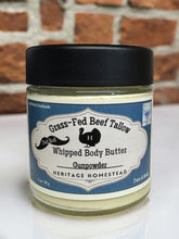 Load image into Gallery viewer, Jar of Grass-Fed Beef Tallow Whipped Body Butter with a black lid against a brick wall background.