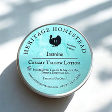 Load image into Gallery viewer, Heritage Homestead Creamy Tallow Lotion tin with jasmine scent on a light background