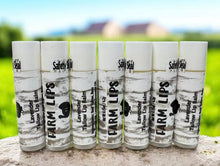 Load image into Gallery viewer, Row of Farm Lips lip balms on a stone surface with a blurred natural background