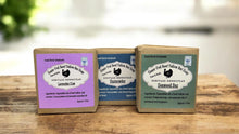 Load image into Gallery viewer, Three soap bars with packaging on a wooden surface. Natural beef tallow soap bars (3 for $20) made with grass-fed tallow for deeply moisturizing, non-toxic skincare. Ideal for dry skin, sensitive skin, and eczema relief.