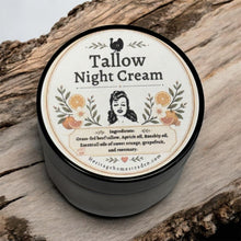 Load image into Gallery viewer, A round amber jar of Tallow Night Cream by Heritage Homestead sits on a rustic piece of wood.