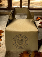 Load image into Gallery viewer, Small brown box with heritage homestead logo on it sitting on a porch with dried fall leaves around it. Includes our 5 tallow lip balms.