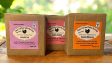 Load image into Gallery viewer, Three wrapped bars of tallow soap with labels on a wooden surface.