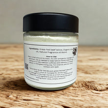 Load image into Gallery viewer, Back label for natural tallow tattoo butter jar with ingredients and how to use on natural wood countertop and grey blurred background.