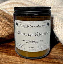 Load image into Gallery viewer, Tallow and beeswax candle labeled 'Wollen Nights' by Heritage Homestead on a wooden surface with yarn in the background.