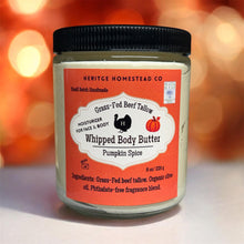 Load image into Gallery viewer, 8 oz jar of Heritage Homestead Co. Grass-Fed Beef Tallow Whipped Body Butter in Pumpkin Spice, with a warm orange label featuring a pumpkin illustration, photographed against a cozy autumn background with glowing lights.