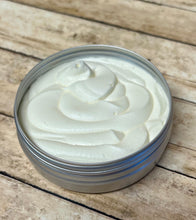 Load image into Gallery viewer, creamy whipped tallow in a tin on a wooden surface shown as an example for DIY skincare with tallow