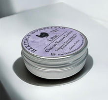 Load image into Gallery viewer, Heritage Homestead Lilac Creamy Tallow Lotion jar on a white surface showing the side view 
