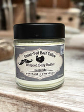 Load image into Gallery viewer, Glass jar of whipped body butter with a black lid on a wooden surface
