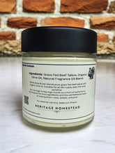 Load image into Gallery viewer, Jar of Heritage Homestead product with black lid on a white surface against a brick wall background
