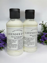 Load image into Gallery viewer, Two bottles of Lavender &amp; Mint Hair Conditioner made with bovine collagen by Heritage Homestead Co., displayed upright with black flip-top caps. The labels feature clean black text detailing ingredients like jojoba oil, collagen, and essential oils. The bottles are set against a white background, surrounded by sprigs of fresh lavender and greenery, highlighting the product&#39;s natural and refreshing essence.
