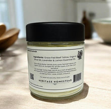 Load image into Gallery viewer, Jar of Heritage Homestead body butter with a label on a wooden surface

