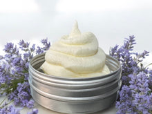 Load image into Gallery viewer, whipped tallow creamy lotion in a small tin sitting on a white counter with lavender flowers placed around the base. 
