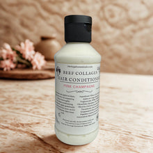 Load image into Gallery viewer, Bottle of beef collagen hair conditioner on a wooden surface with a blurred background
