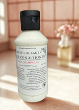 Load image into Gallery viewer, Bottle of beef collagen hair conditioner on a wooden surface with a soft, warm pink background.
