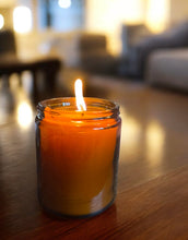 Load image into Gallery viewer, Candle in a glass jar on a wooden table with a blurred background

