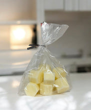 Load image into Gallery viewer, Clear cellophane bag with wrapped candies on a blurred kitchen counter
