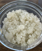 Load image into Gallery viewer, close up of body scrub in a clear container on a wooden surface
