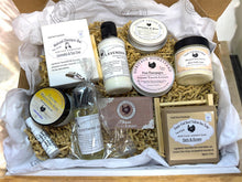 Load image into Gallery viewer, Assorted natural products including soap bars, shampoos, and soap in a box.
