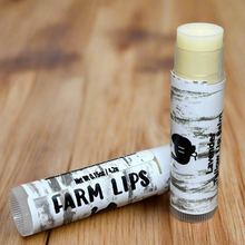 Load image into Gallery viewer, Natural tallow lip balm lavender against plain wooden background 
